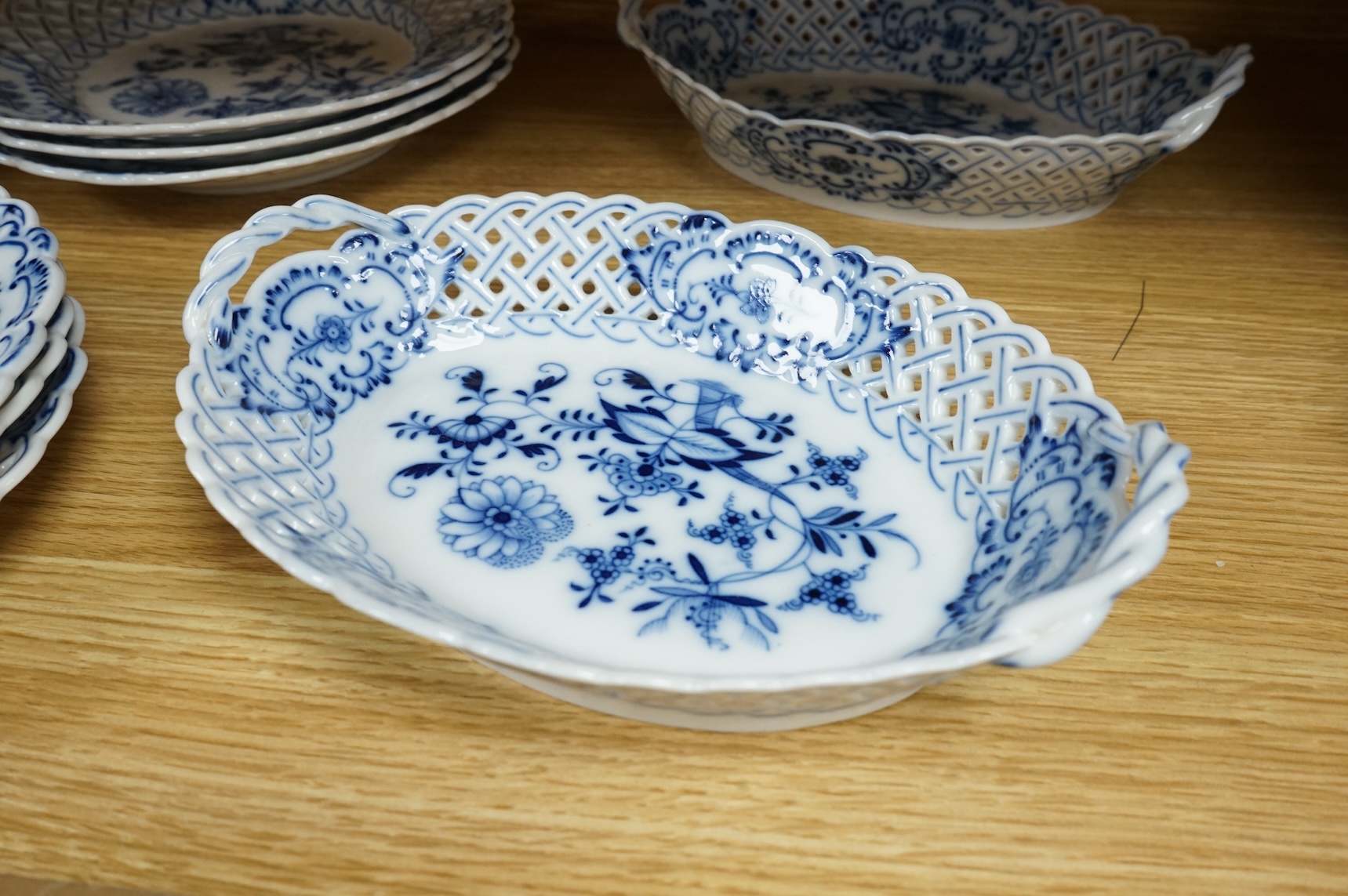 A ‘Meissen’ blue onion pattern dessert service comprising nine plates and two oval twin handled dishes, 24cm wide